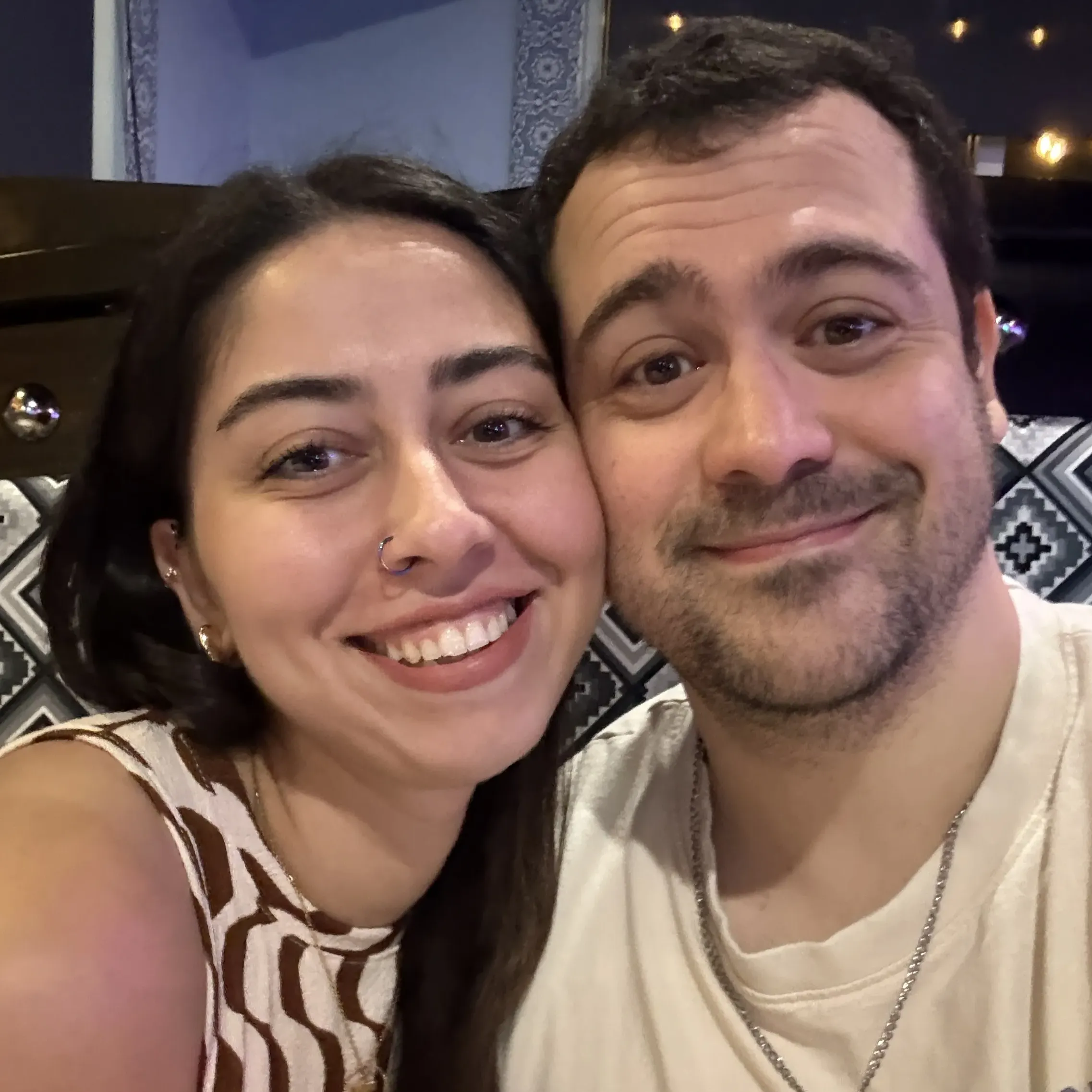 asemin and William smiling together, celebrating their engagement